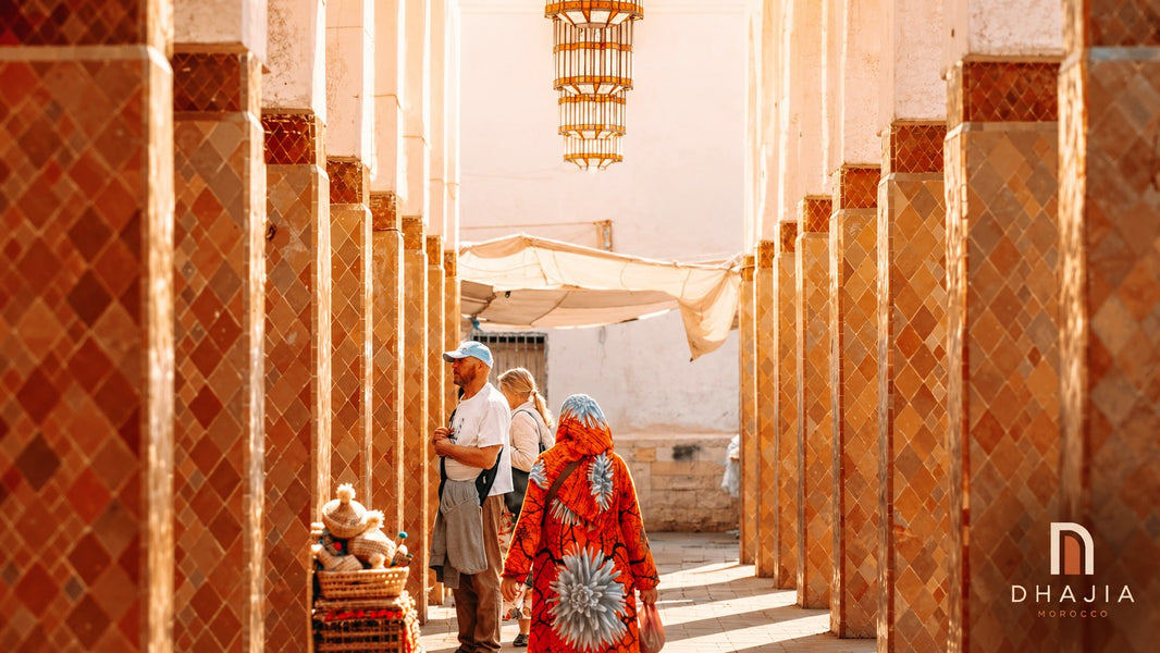Shoppers beneath hanging lanterns in a tiled market passage in Agadir