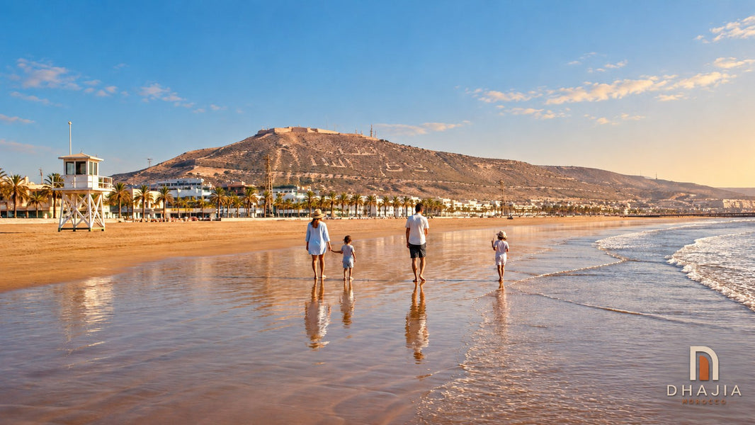 Editorial illustration of a family walking along wet sand beside an Agadir-inspired beachfront and Oufella hillside.