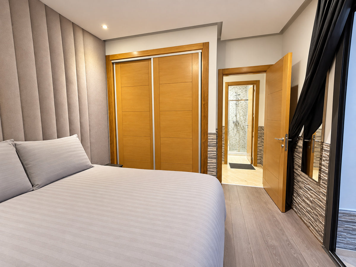 DHAJIA Morocco Hivernage Agadir Bay apartment master bedroom with wardrobe and bathroom view
