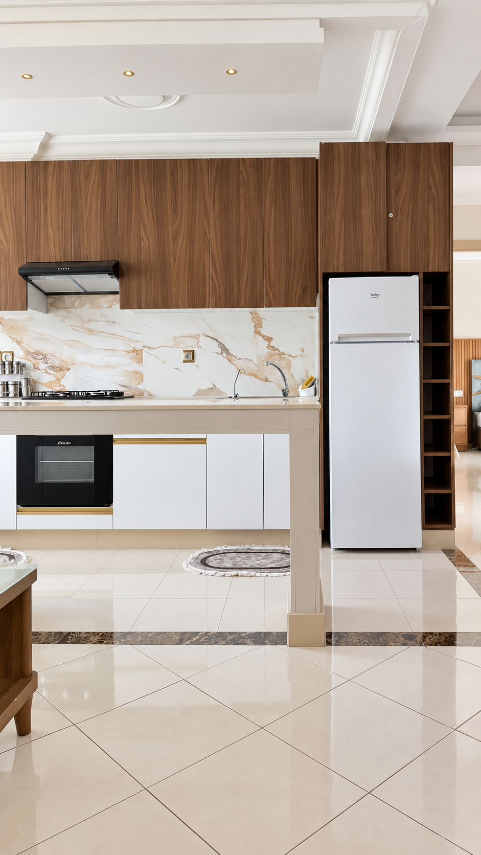 Kitchen with white cabinets and refrigerator at the Hay Mohammadi Premium holiday apartment, Agadir