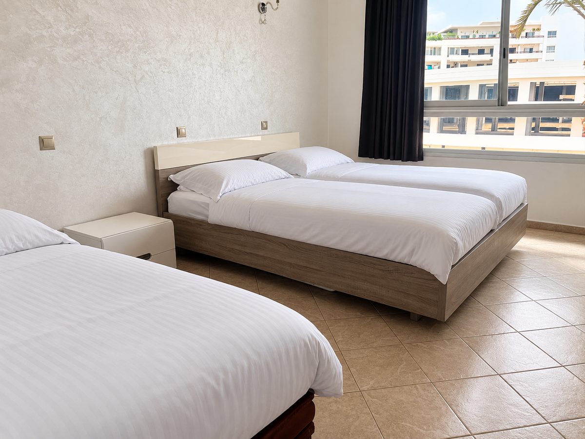 Twin bedroom with light bedding — 2-Bed Apartment for Sale in Agadir Marina | DHAJIA Morocco