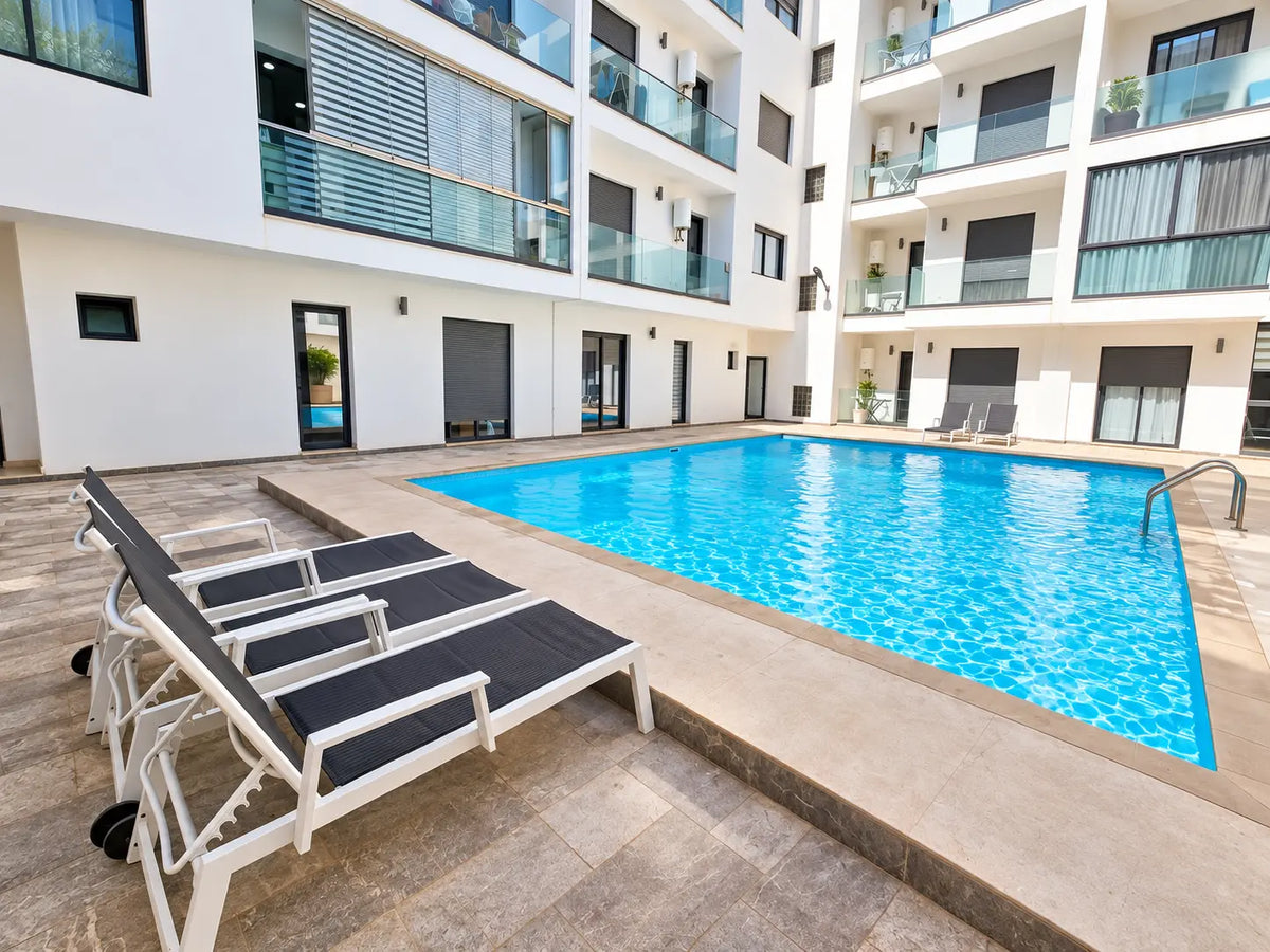Pool & residence | Wide daytime view of the Agadir Bay 3 pool and loungers