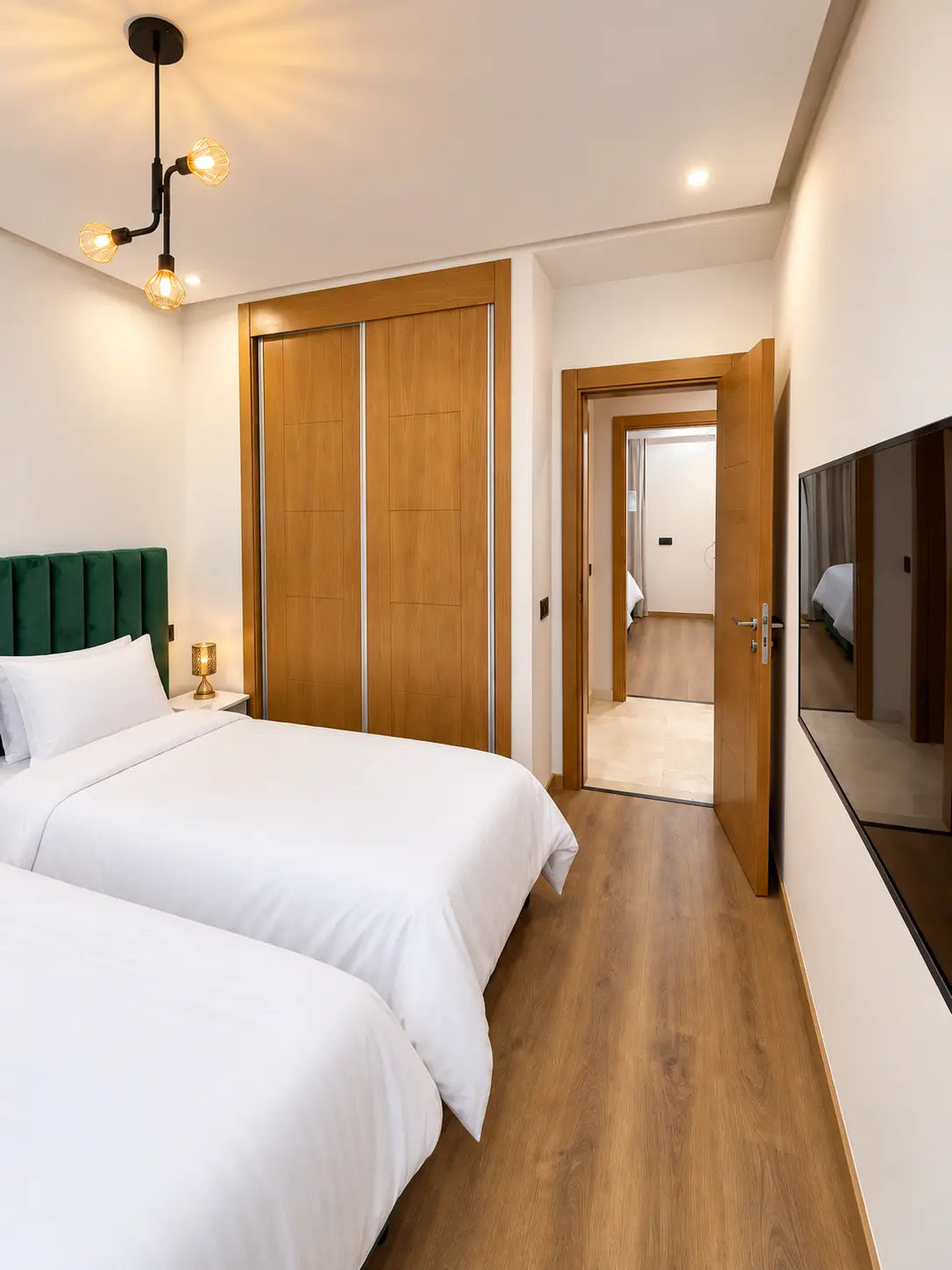 Twin bedroom | Twin bedroom TV and doorway view