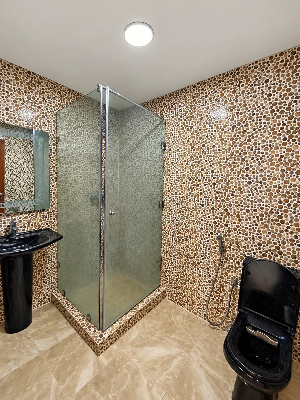Tiled bathroom with enclosed shower
