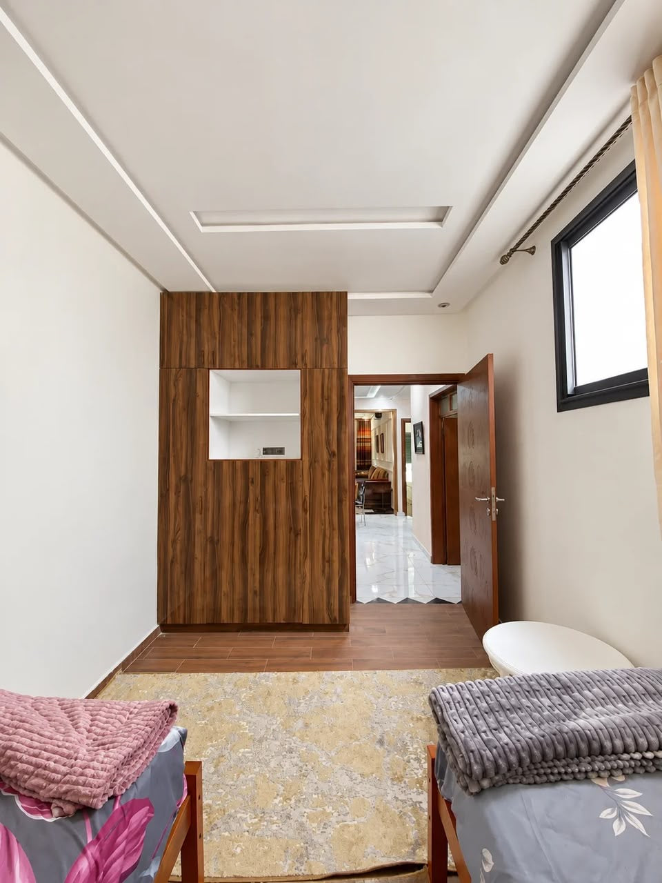 Twin bedroom storage and hallway view