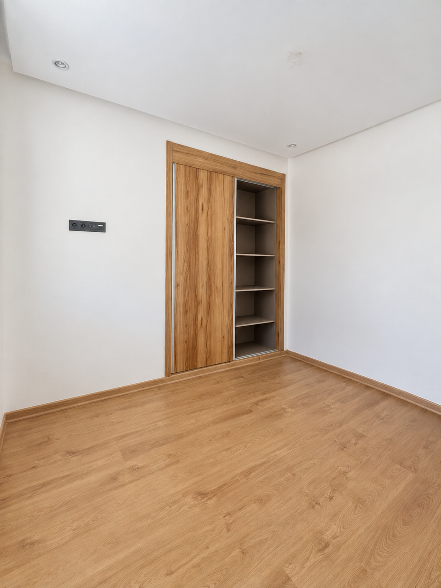 Empty bedroom with built-in wood wardrobe in the Founty apartment