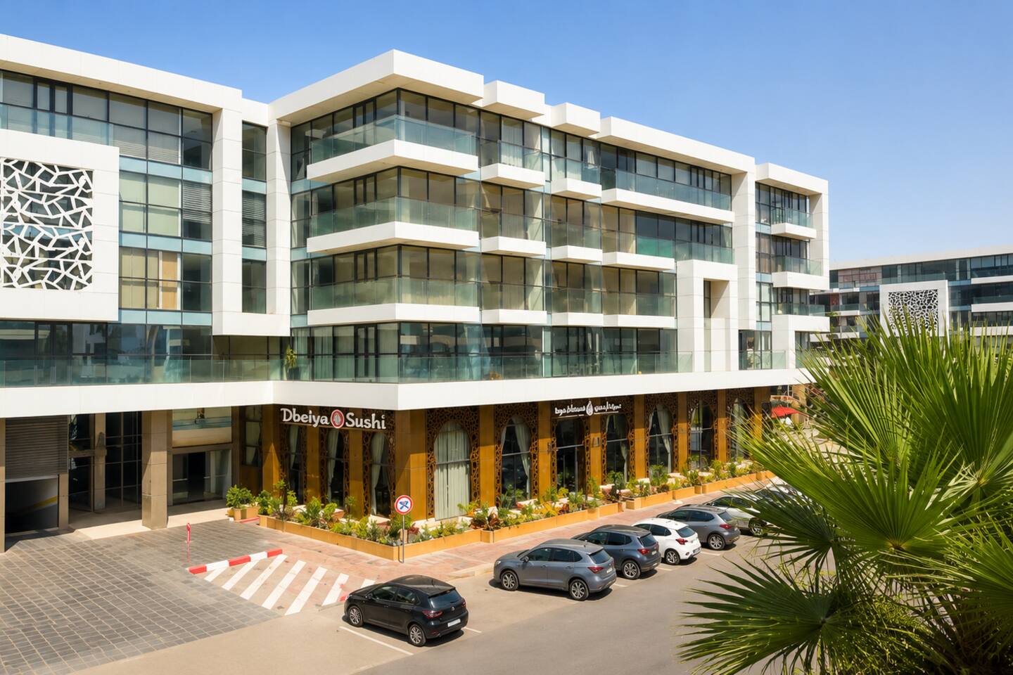 Modern buildings and palm trees in the Agadir Bay neighbourhood.