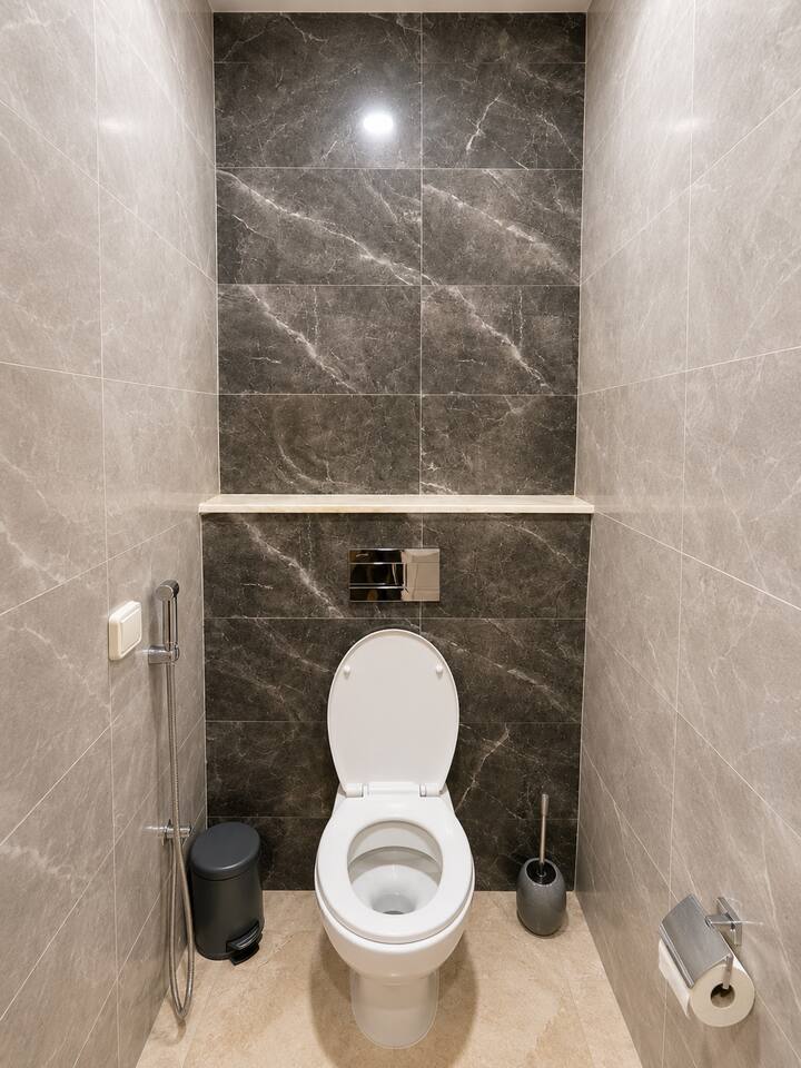 Bathroom toilet and tiled shower area in the Agadir Bay apartment.