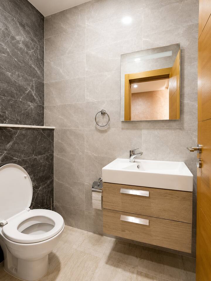 Bathroom with vanity, mirror and toilet in the Agadir Bay apartment.
