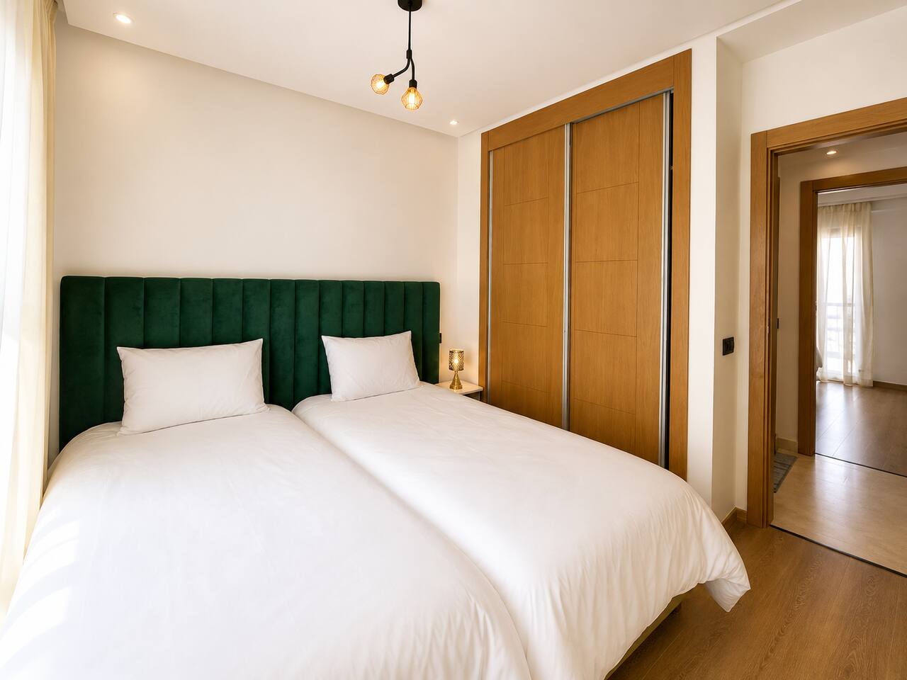 Main bedroom with fitted wood wardrobes in the Agadir Bay apartment.