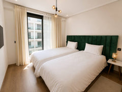 Main bedroom with large window and soft neutral bedding in Agadir Bay.