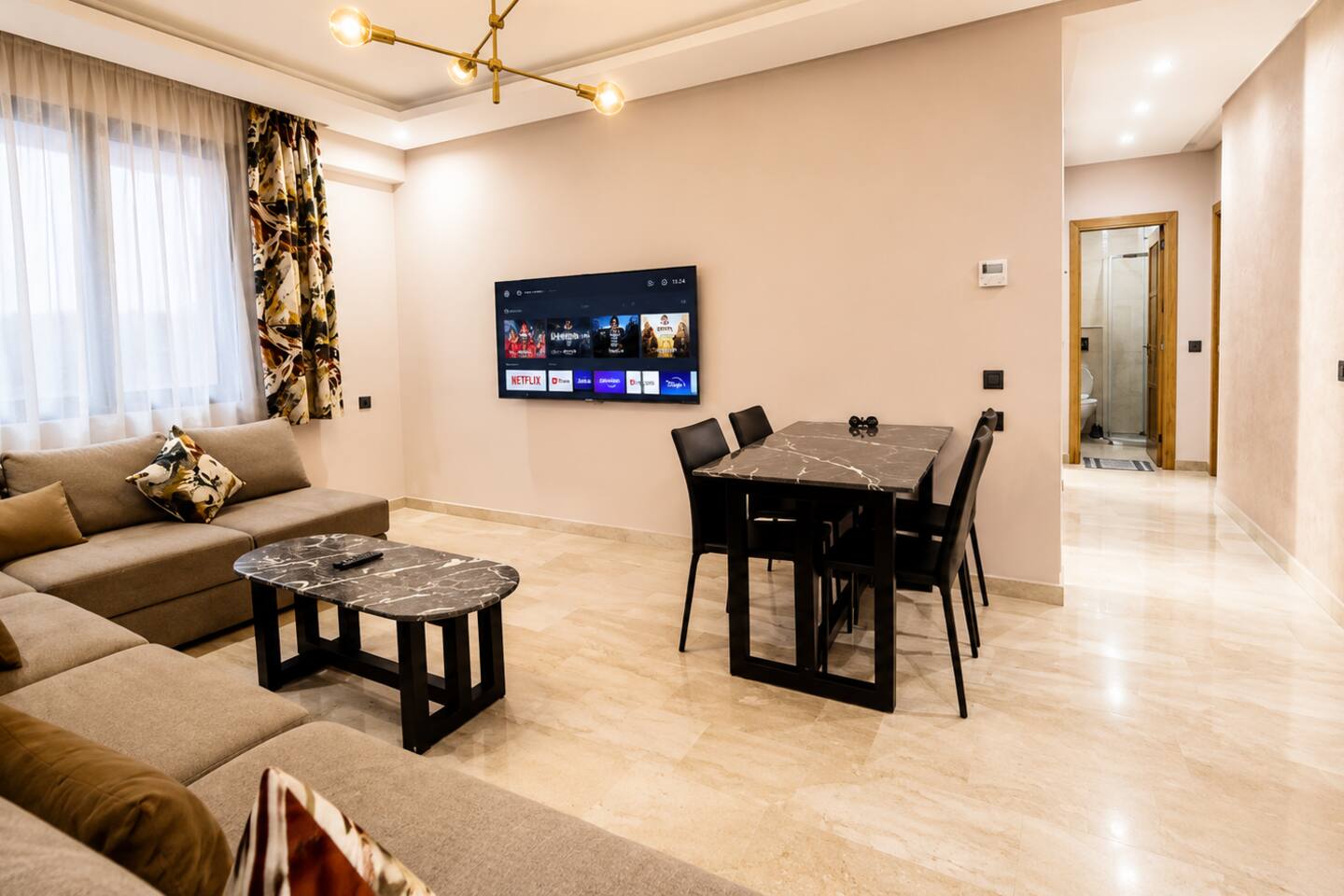 Wide view of the open-plan living and dining room in the Agadir Bay apartment.