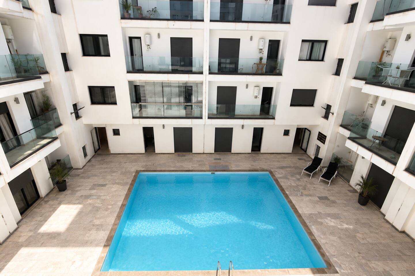 Communal pool courtyard surrounded by apartments at the Agadir Bay residence.