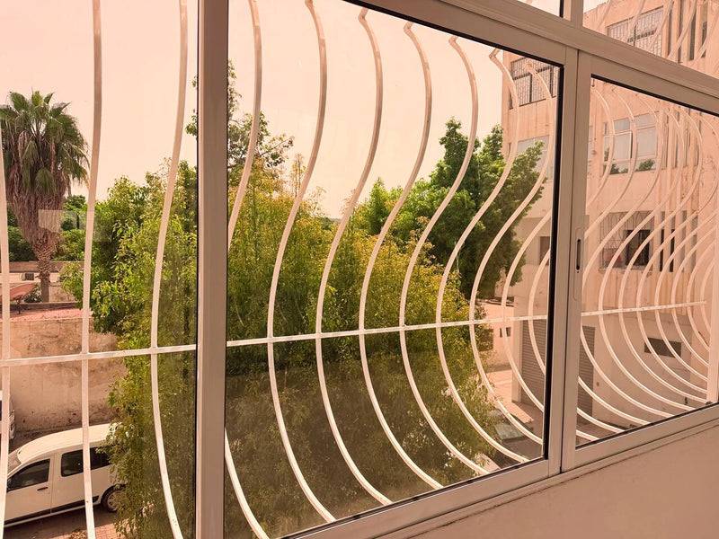 Bedroom window overlooking greenery in the central Agadir apartment.