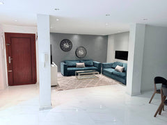Entrance hall opening into the blue-sofa living room in central Agadir.