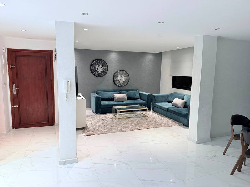 Entrance hall opening into the blue-sofa living room in central Agadir.