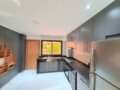 Fitted grey kitchen with large window in the central Agadir apartment.