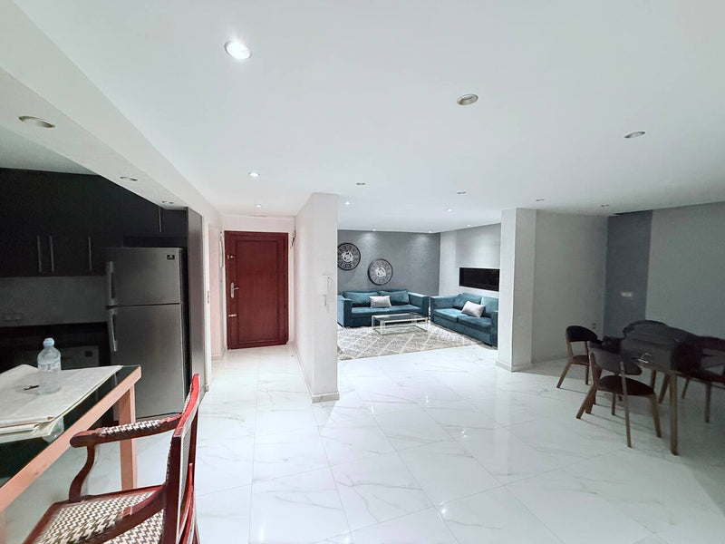 Wide open-plan living and dining area in the central Agadir apartment.