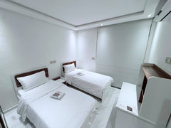 Wide view of the twin bedroom with two single beds in central Agadir.