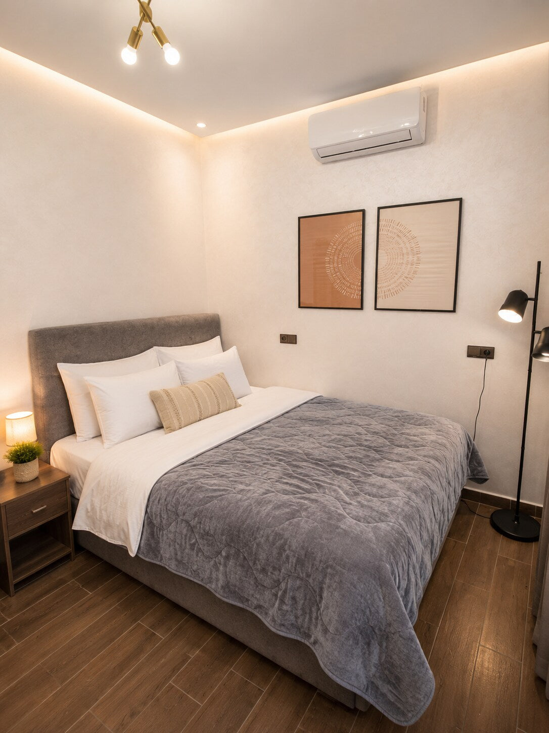 Main bedroom with large bed, air conditioning and warm lighting in Haut Founty, Agadir.