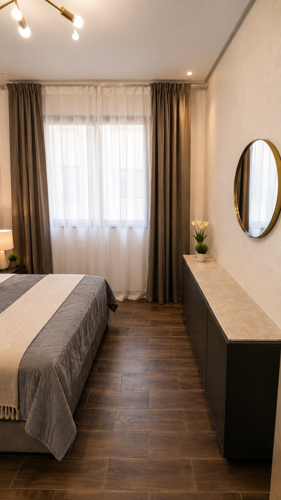 Main bedroom with curtains, dresser and mirror in the Haut Founty apartment.