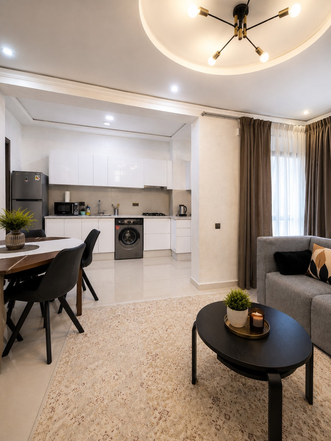 Open-plan dining, kitchen and lounge area in the Haut Founty apartment.