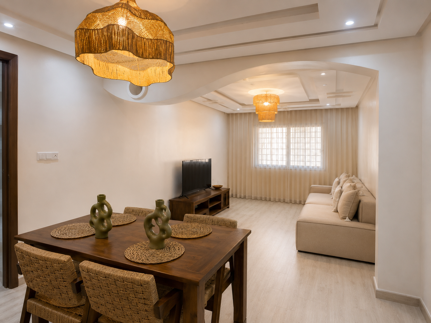 Open living and dining room with Moroccan-inspired pendant lights in the Haut Founty apartment.