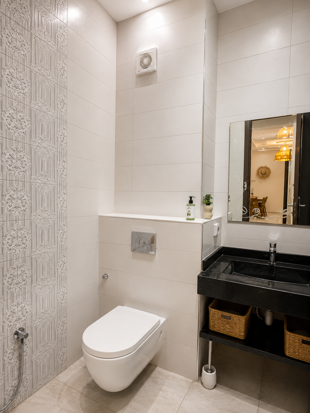Second bathroom with wall-mounted toilet and vanity in the Haut Founty apartment.
