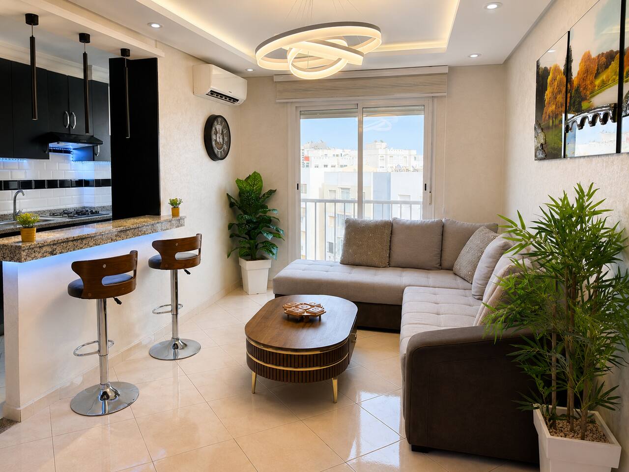 Living room seating and breakfast bar beside a bright window in Hay Mohammadi.