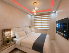 Main bedroom with double bed, smart TV and red ceiling lighting in Hay Mohammadi.
