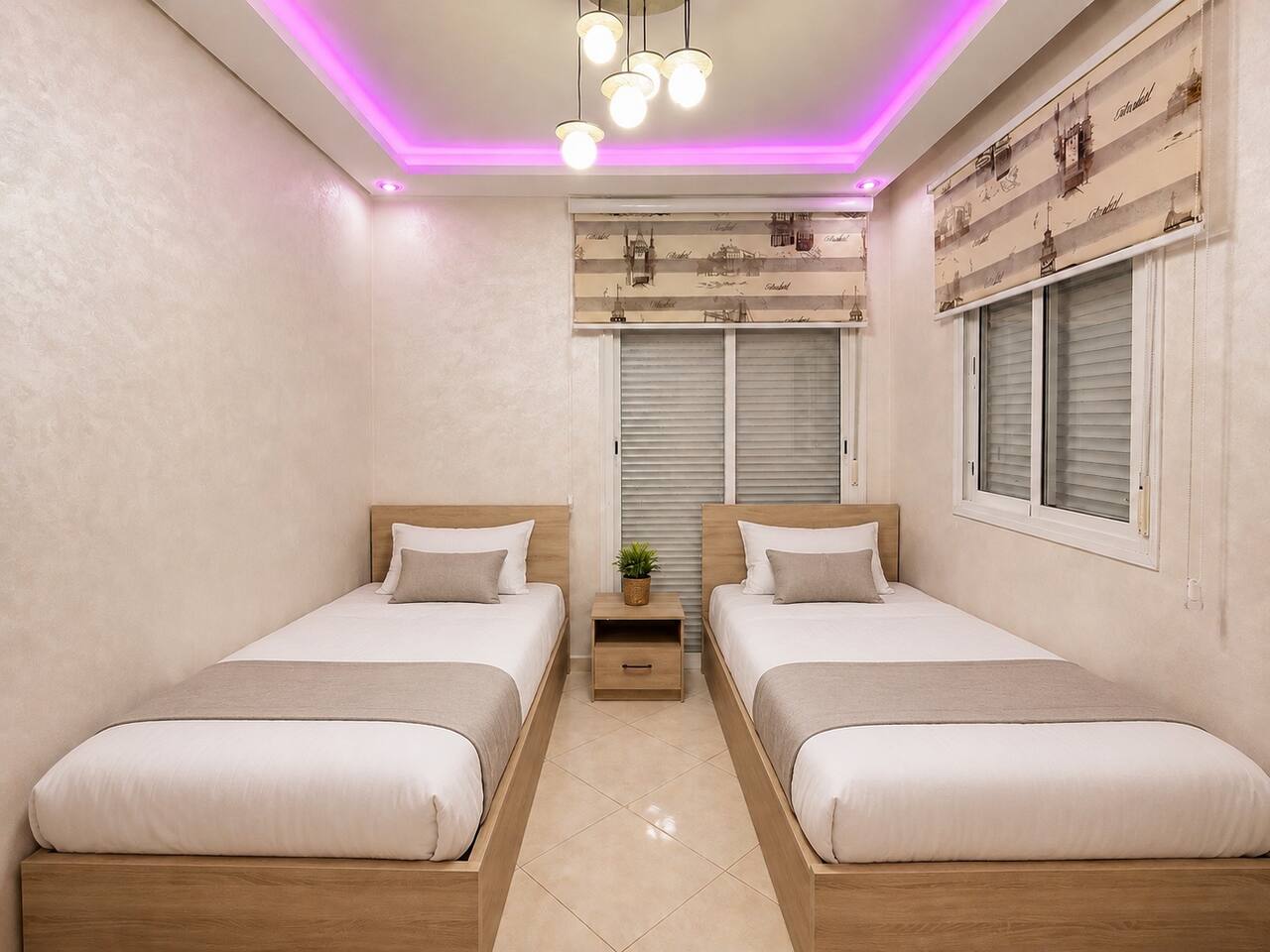 Twin bedroom with two single beds and purple ceiling lighting in Hay Mohammadi.