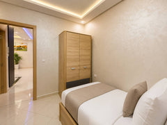 Twin bedroom with wardrobe and two prepared single beds in Hay Mohammadi.