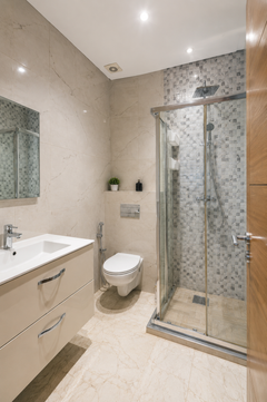 Modern bathroom with vanity and walk-in shower in the Hivernage Agadir Bay apartment.