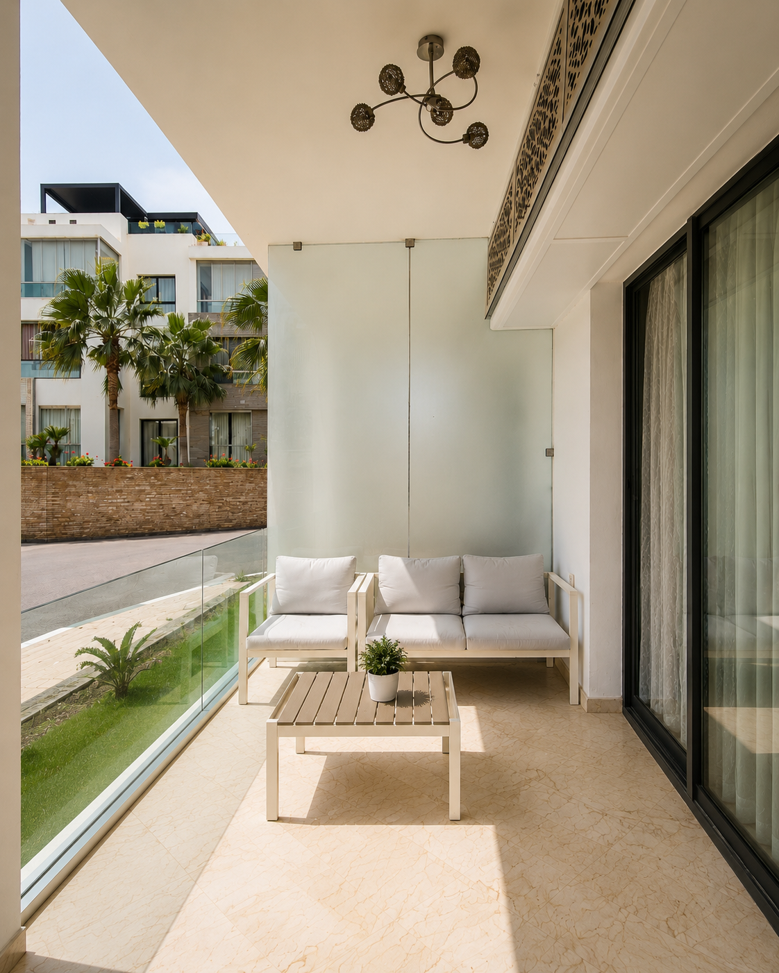 Covered apartment balcony overlooking Hivernage Agadir Bay residence grounds.