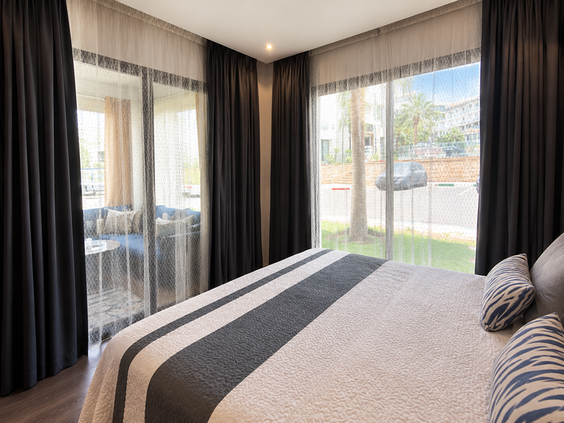 Main bedroom with direct balcony access in the Hivernage Agadir Bay apartment.