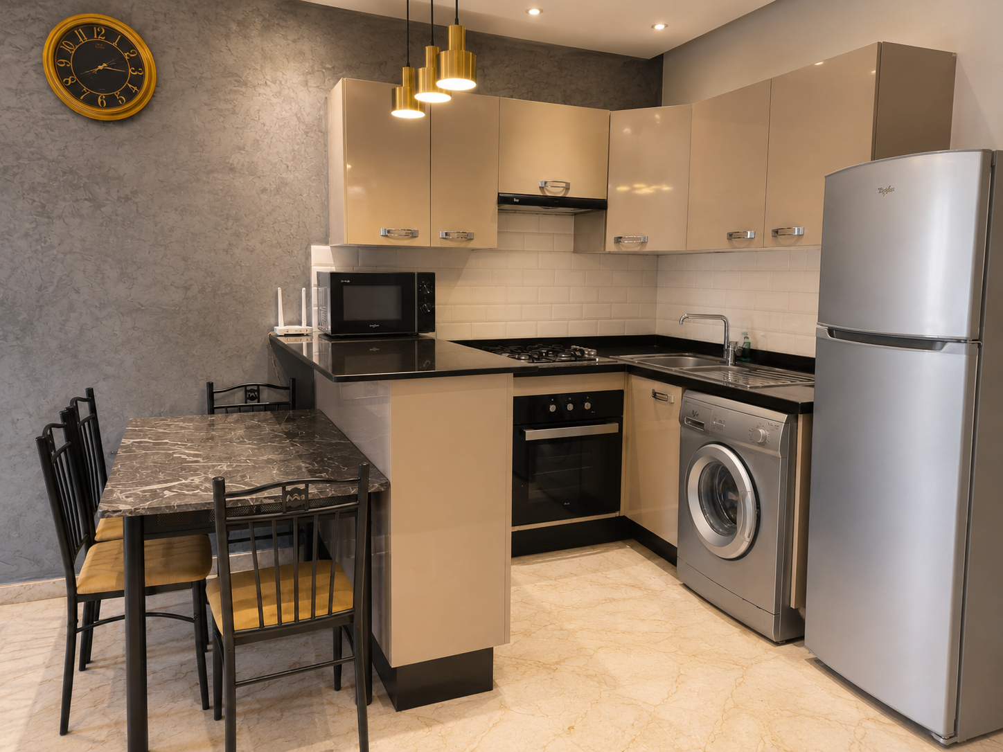 Open-plan kitchen and dining area with washing machine in the Hivernage apartment.