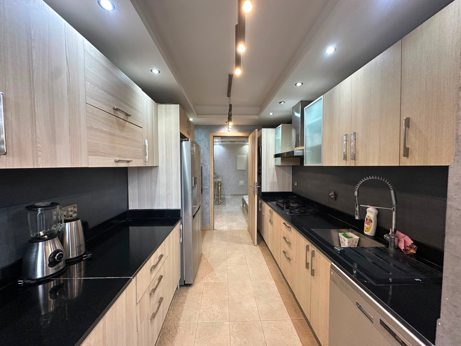 Full fitted kitchen with gas hob, dishwasher and preparation space at Iken Gardens.