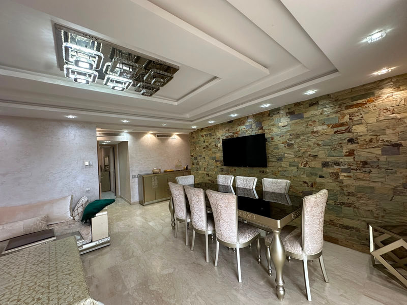 Elegant living and dining area at the Iken Gardens apartment in Agadir Bay.