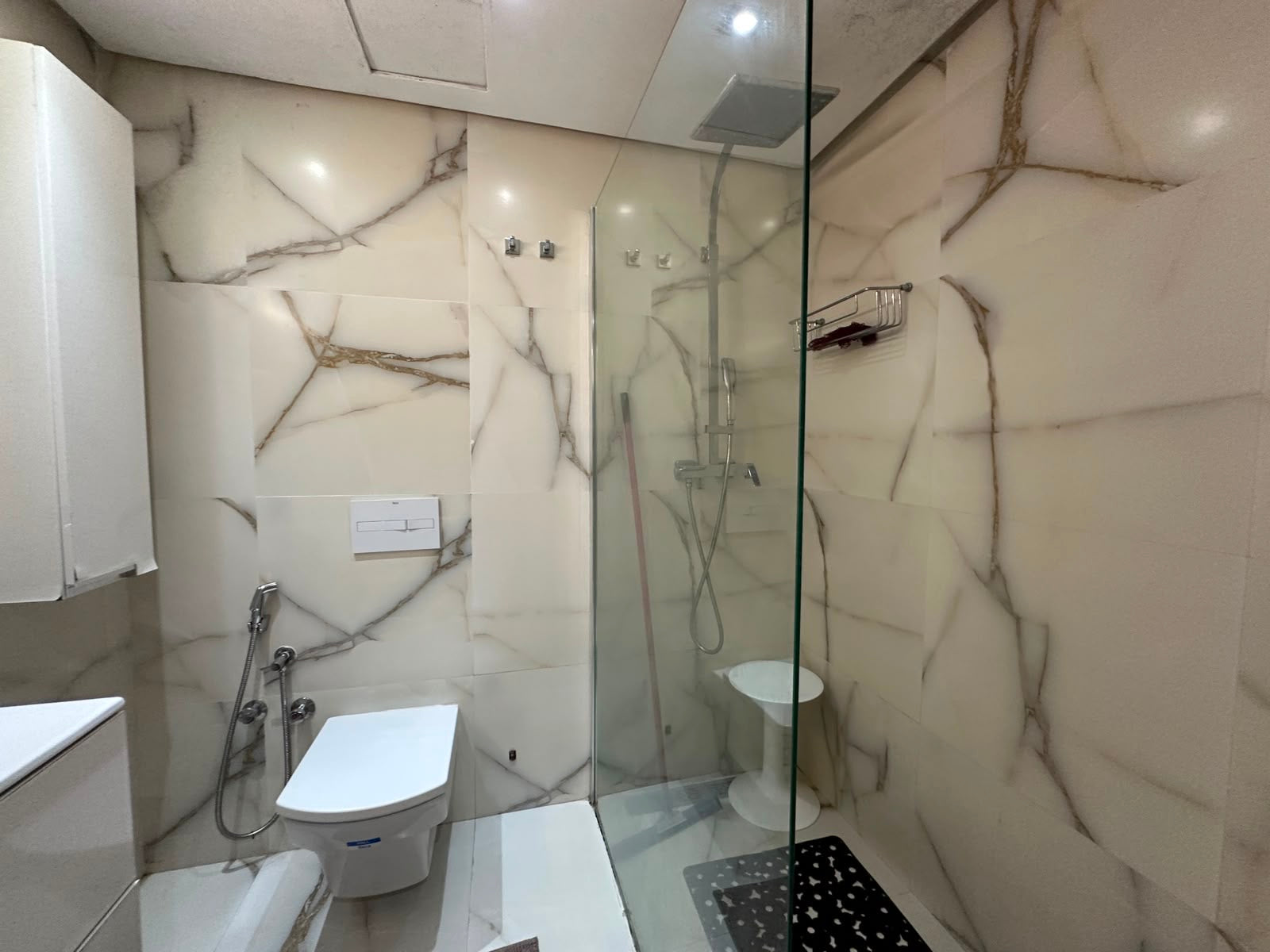 Modern marble-effect shower room at the Iken Gardens apartment in Agadir Bay.