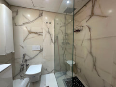 Modern marble-effect shower room at the Iken Gardens apartment in Agadir Bay.
