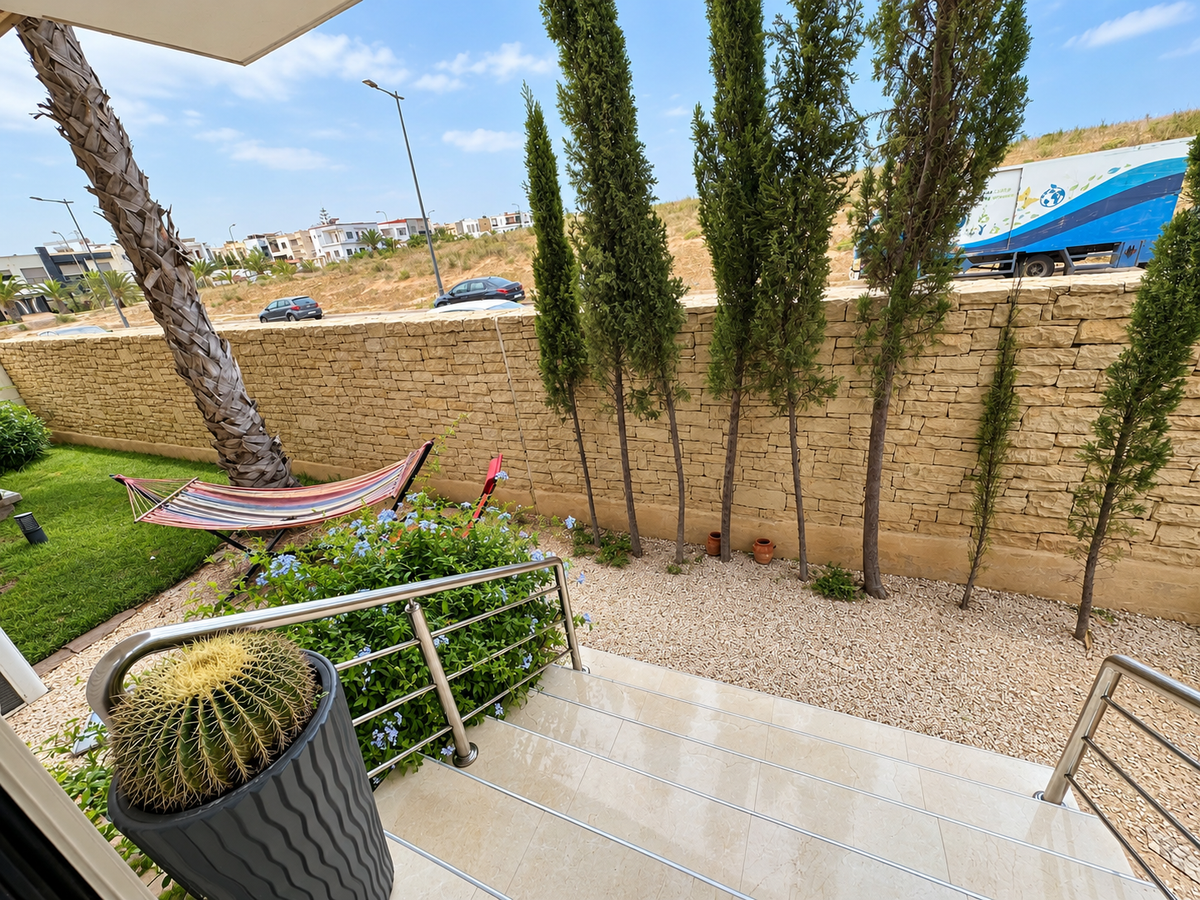 Private garden with outdoor chairs at the Iken Gardens holiday apartment, Agadir Bay