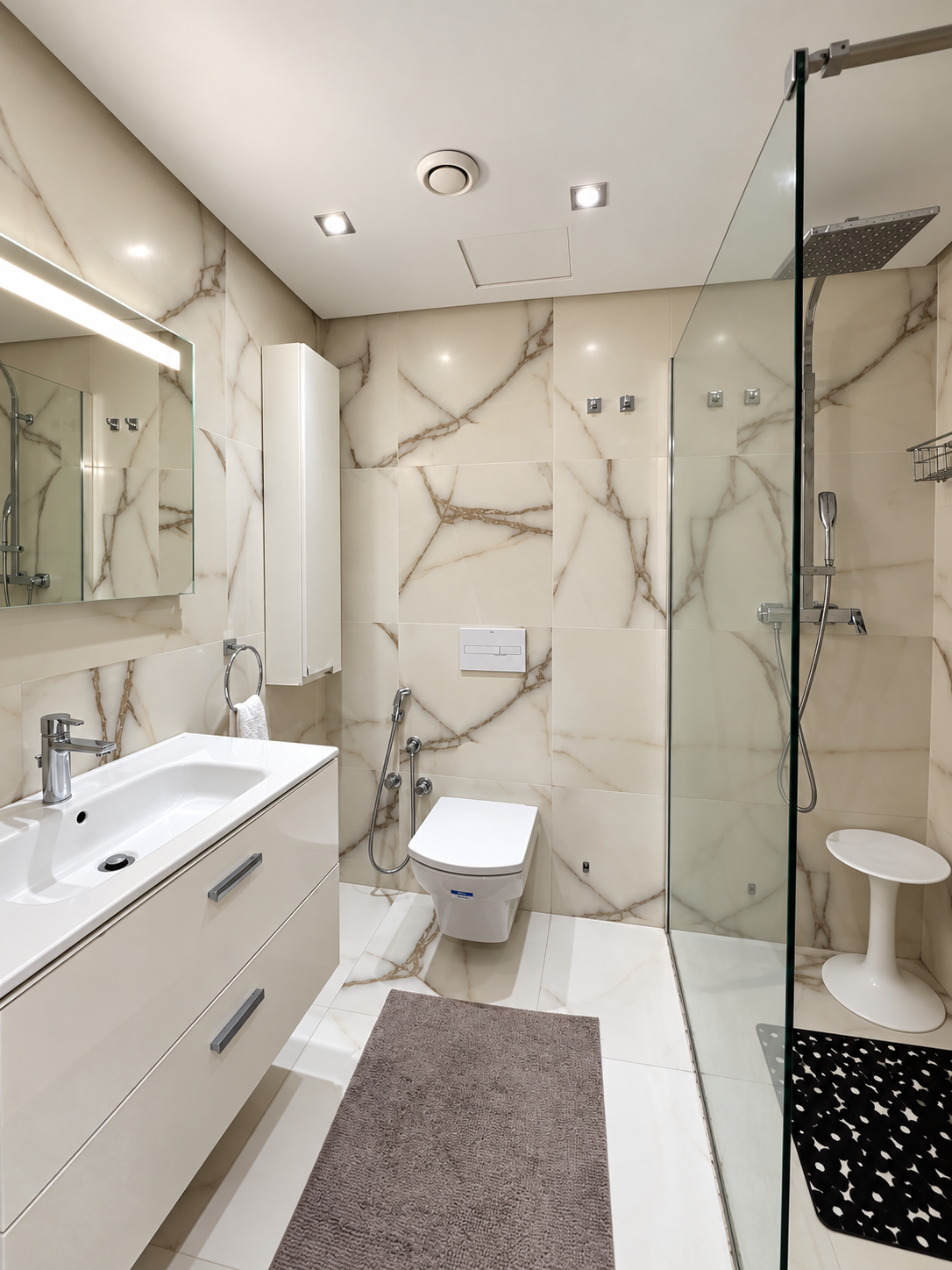 Bathroom with marble-effect tiles at the Iken Gardens holiday apartment, Agadir Bay
