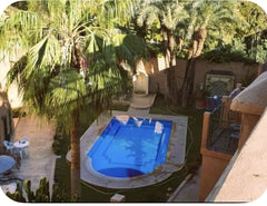 Courtyard swimming pool and palms at the Marrakech riad residence