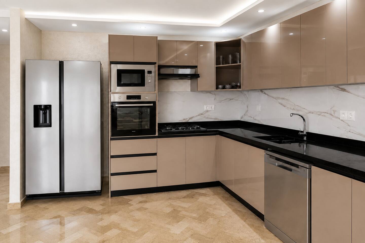 Full view of the fitted kitchen with fridge, oven and black worktops near Agadir Bay.