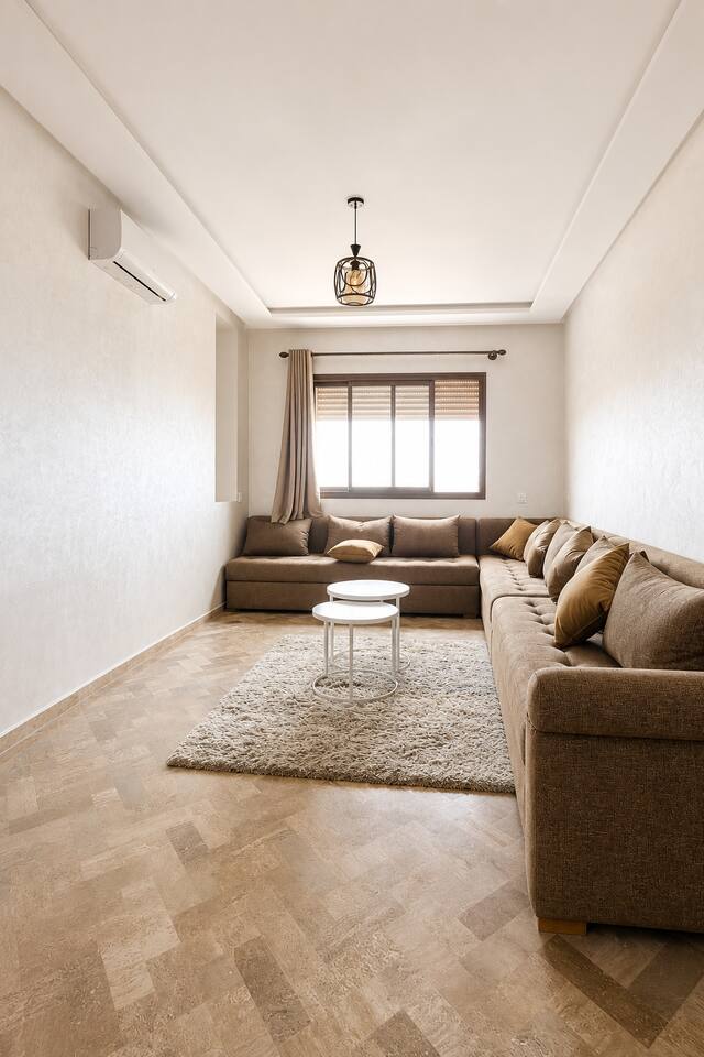 Wide view of the bright living room and corner sofa near Agadir Bay.