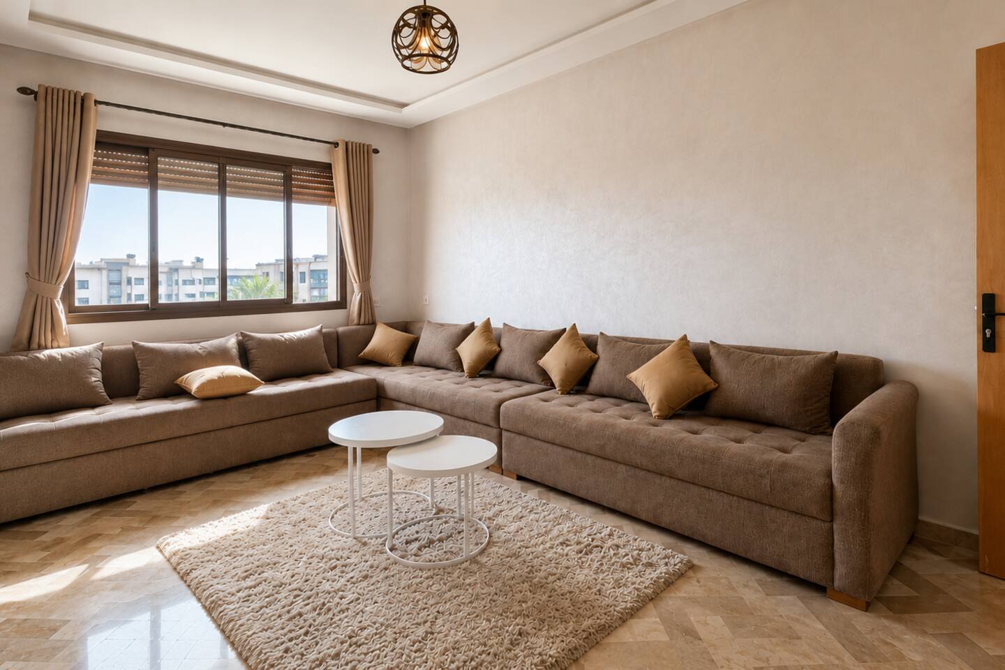 Spacious living room with corner sofa and wide neighbourhood view near Agadir Bay.