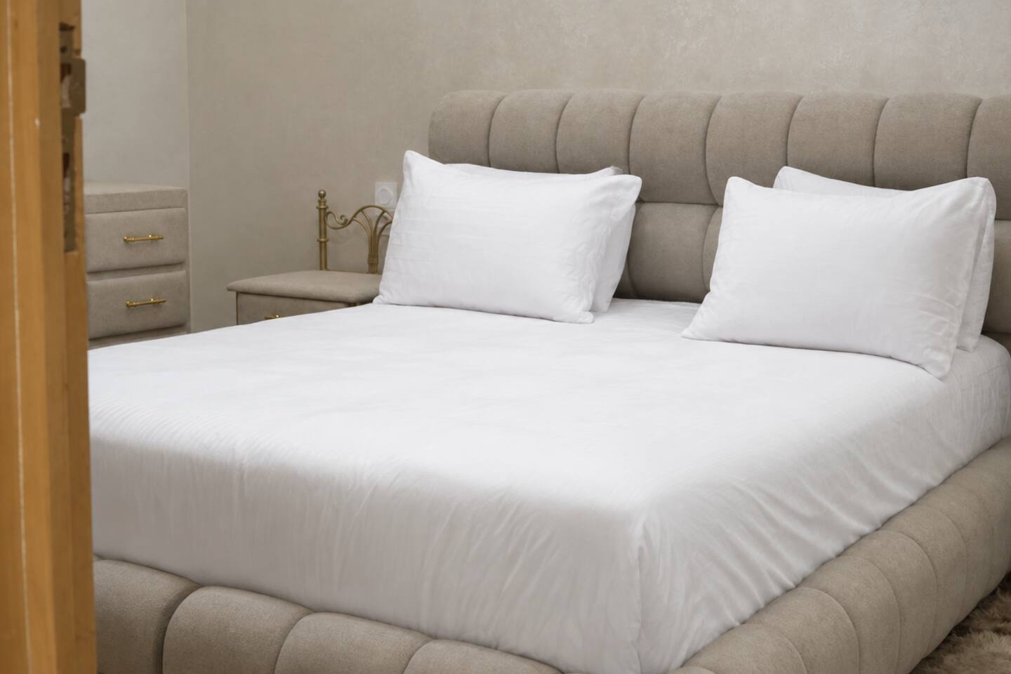 Prepared double bedroom with soft neutral bedding near Agadir Bay.