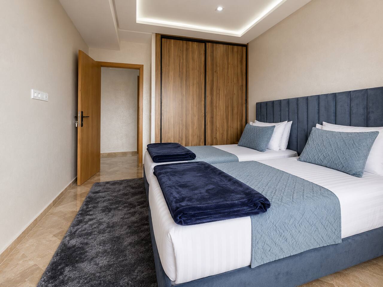 Twin bedroom with two prepared single beds in the premium apartment near Agadir Bay.