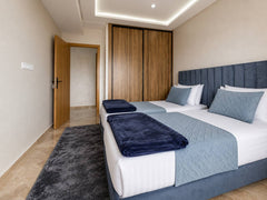 Twin bedroom with two prepared single beds in the premium apartment near Agadir Bay.