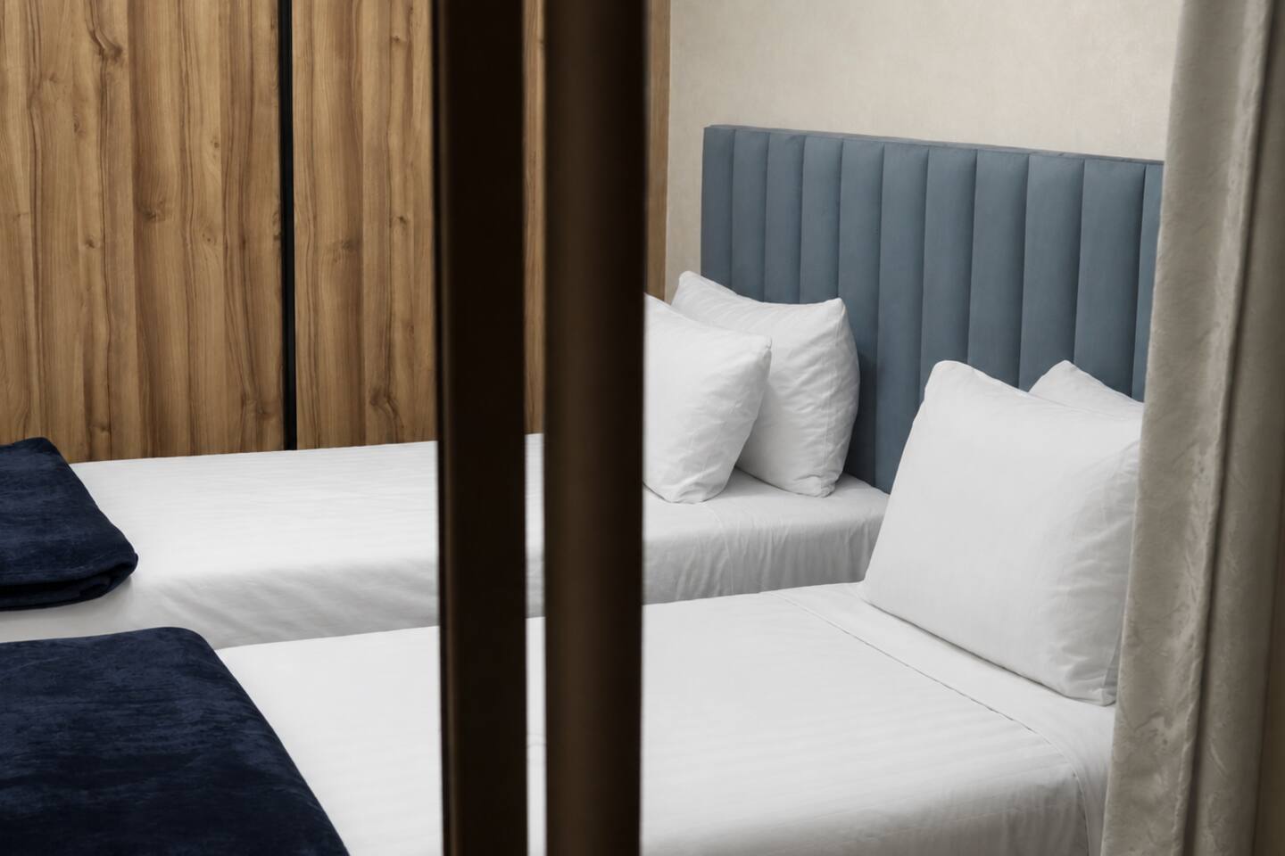 Twin bedroom reflected in the fitted wardrobe mirror near Agadir Bay.